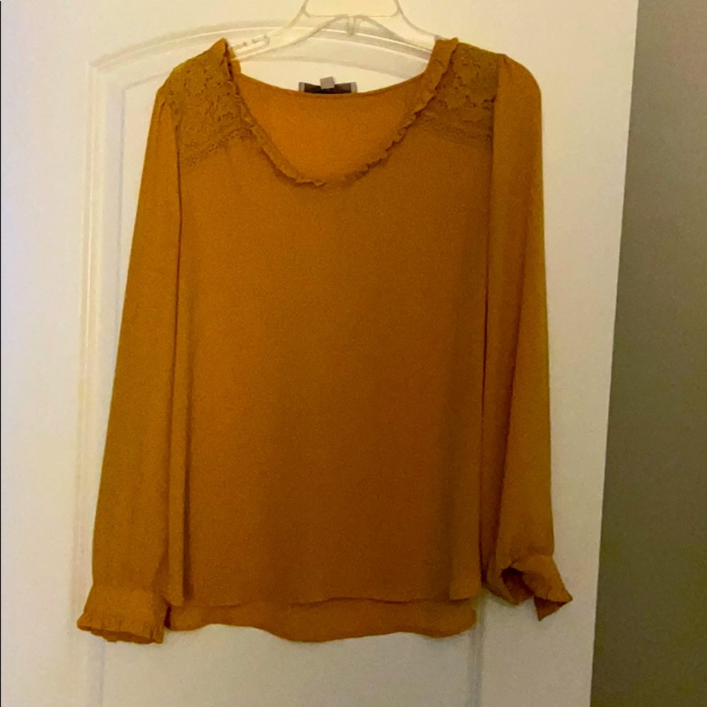 A mustard yellow blouse